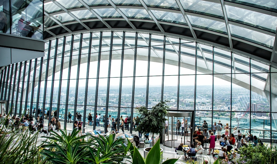 Interior view of Sky Garden with lush greenery and panoramic city views.
