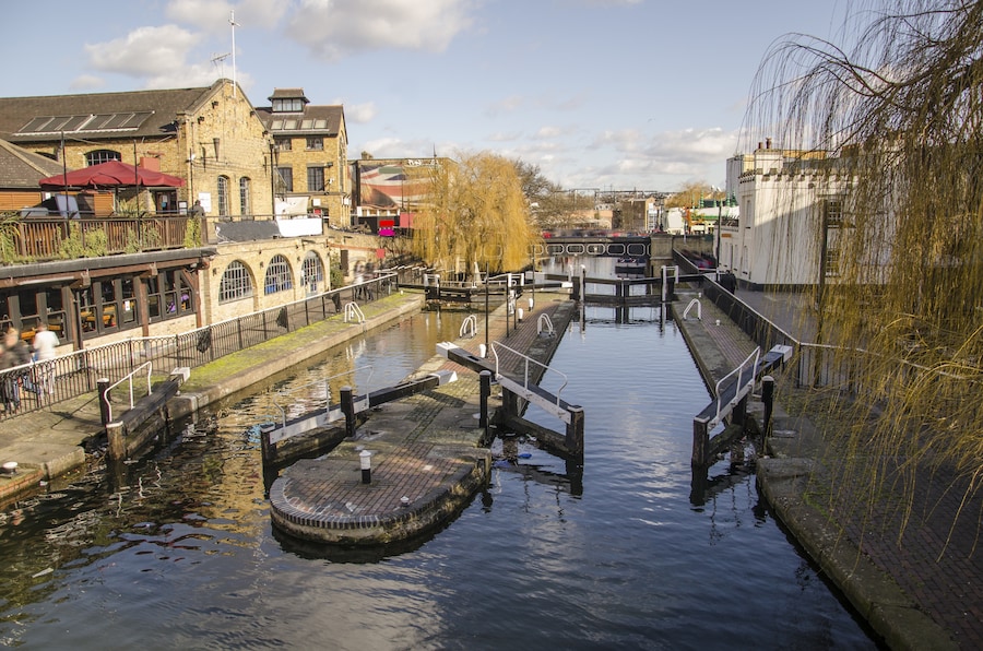View of Camden Market with canal-side shops and vibrant atmosphere.