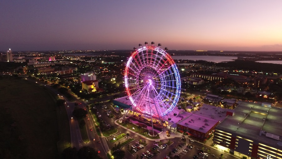 The Wheel at ICON Park (Orlando Eye) glowing at sunset over International Drive skyline, Orlando, Florida.