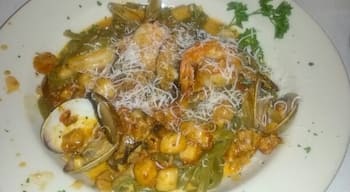 Spinach fettuccine with shrimp, scallops, clams, mussels and portobello mushrooms. 