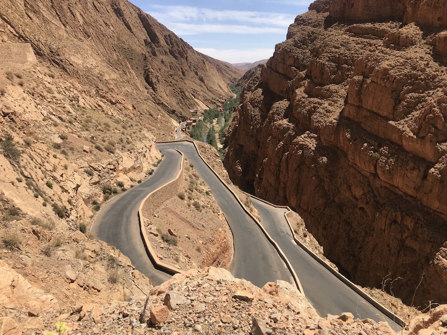 Road leading down into Dades Gorge where an oasis of plants, a Berber village and water live between beautiful sandstone mountains. #dadesgorge #morocco #africa #berber #earthbound #travel #slowtravel #travelmorocco #mountains #sandstonemountains #moroccanmountains #roadtrip #ilovemorocco #flashpackingbarbie