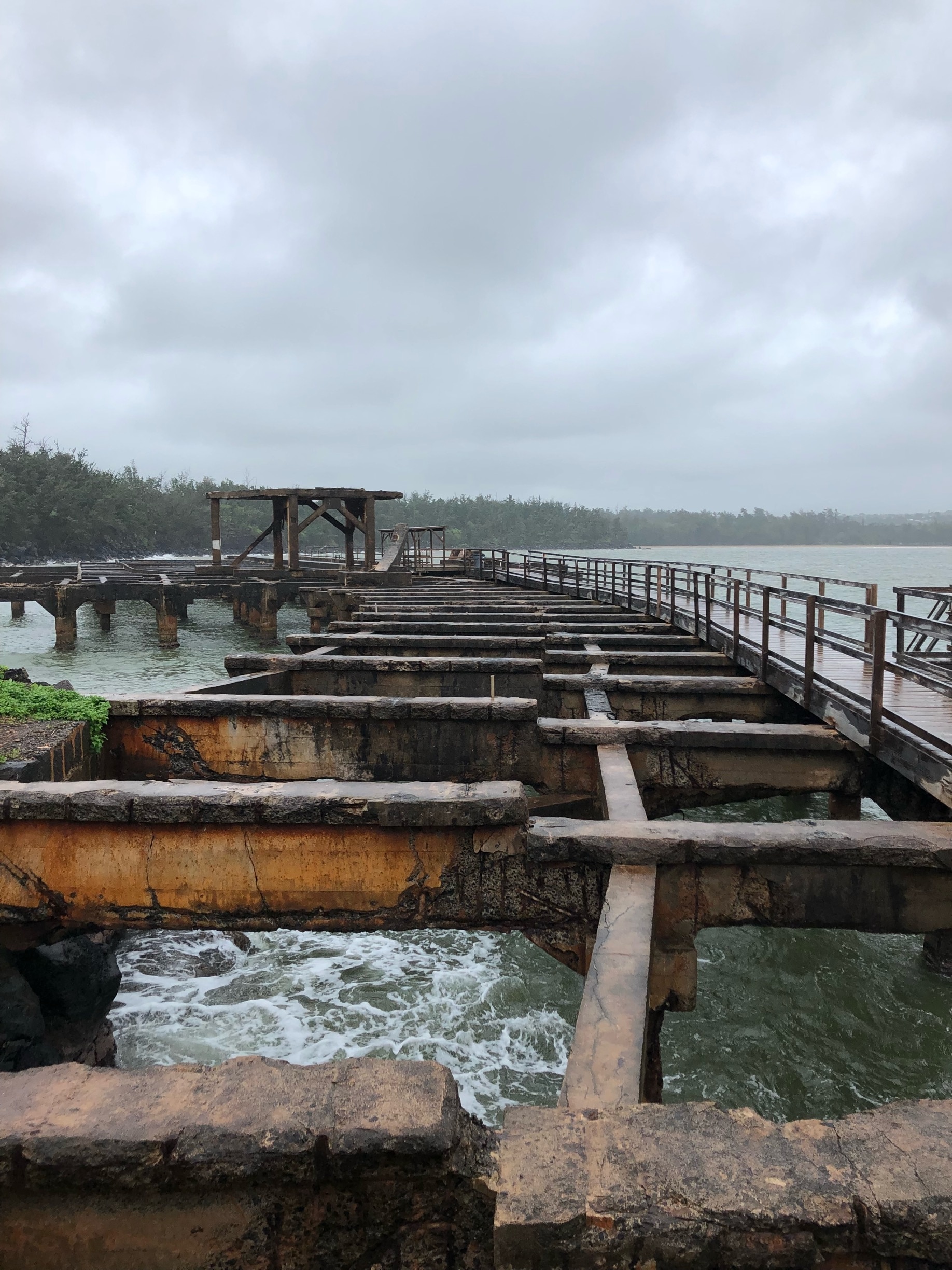 An old pier right near the airport on Kauai. We went in the middle of a storm with huge waves crashing along the rocks. It was windy and cold but still worth checking out. 