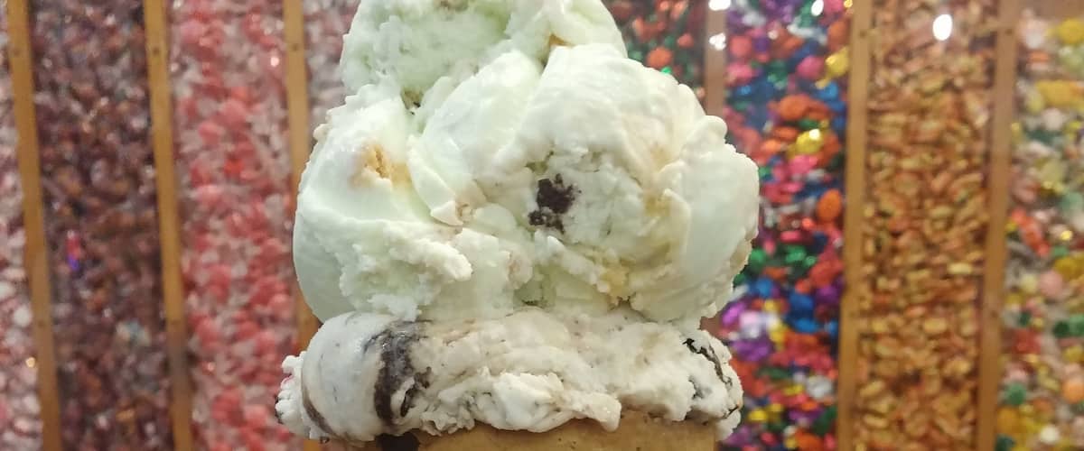 Windy City Sweets has everything you need to accelerate your path to diabetic obese bliss! An all encompassing candy and dessert shop that is almost as visually stimulating as hunger inducing,
Here we have a scoop of key lime pie ice cream and a scoop of trash can (i.e. everything) ice cream served in a chocolate chip cookie cone!