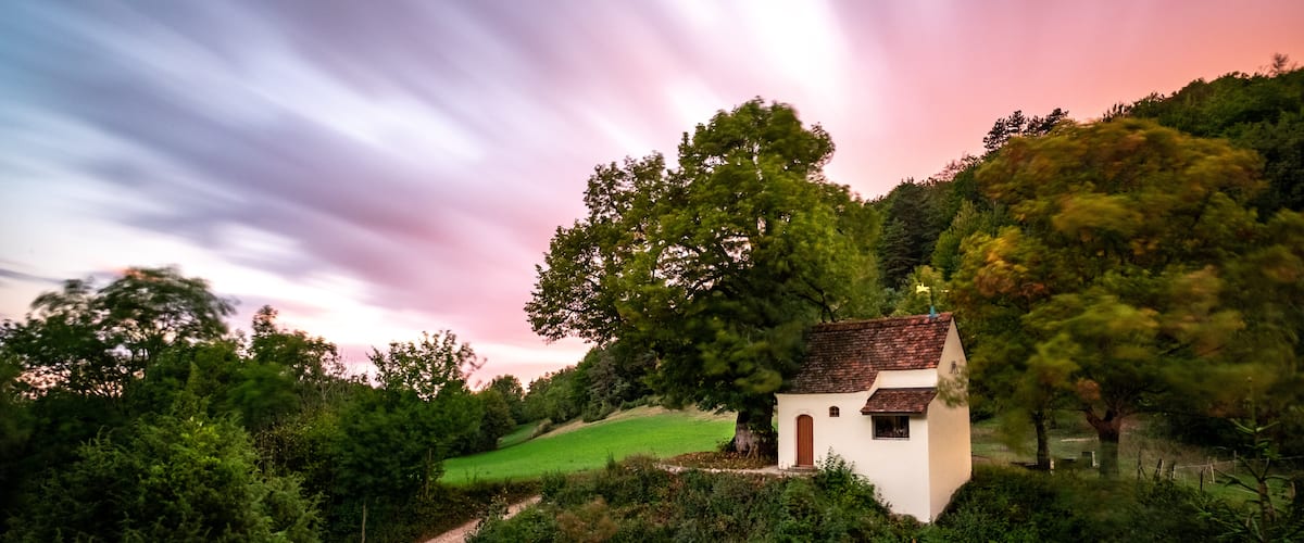 An almost enchanted scenery when getting the shot at such a sunset... (would have not been surprised if Merlin had taken a step out of the door ;)) 
A location, hardly to find if you don't know a local. Hope it can inspire you...
(21mm / f11 / 75sec)