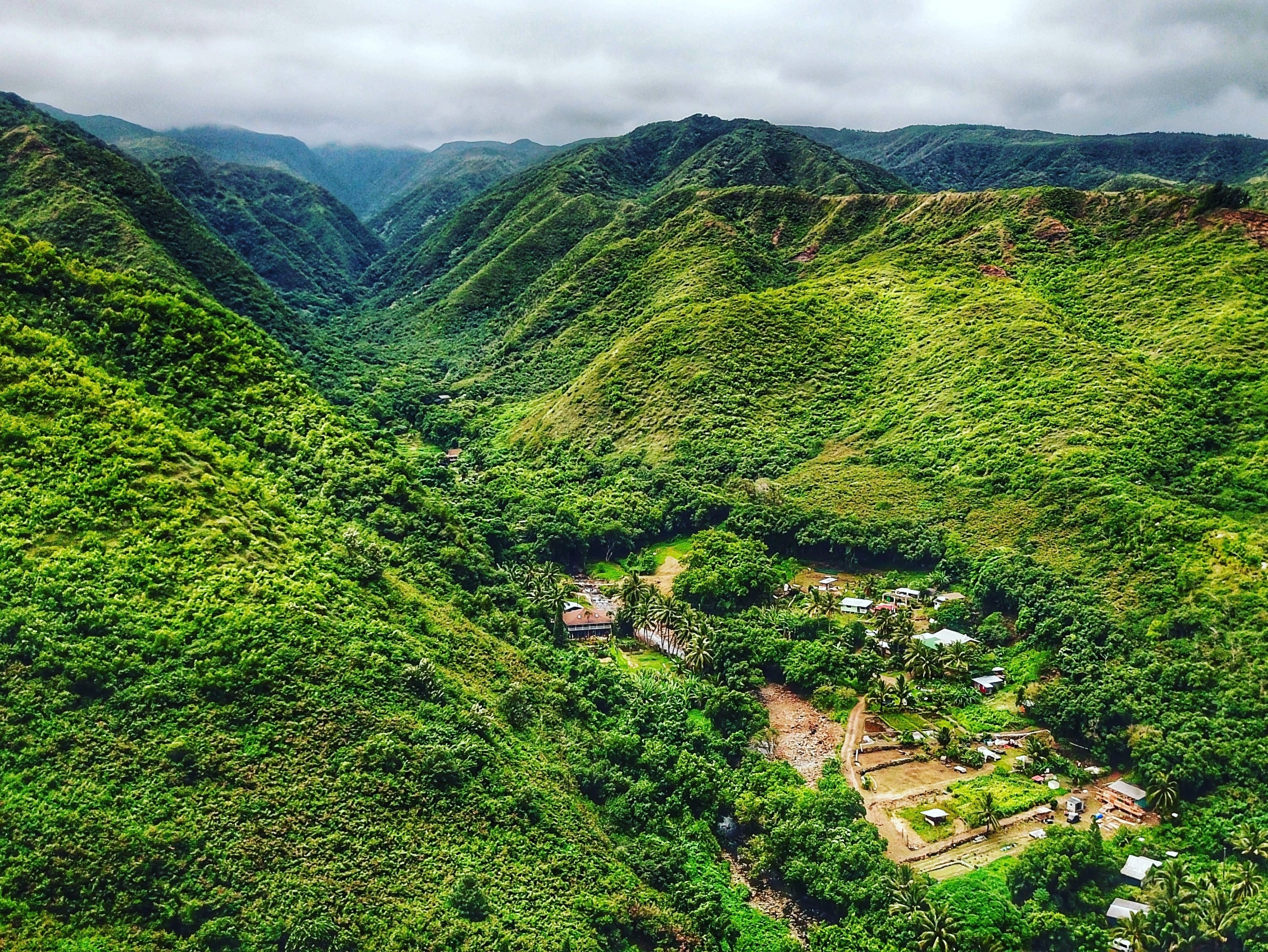 Drone shot from the coast looking up the canyon and over the village. The is one the NE road to the blowhole in Maui