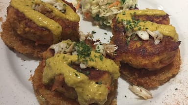 Boudreaux’s Cajun Grill serves fried green tomatoes topped with lump crab and sauce over crawfish cakes and the best view of Mobile Bay  #trovember