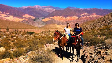 Rent a horse (& guide) to explore the area around Tilcara and admire the incredible multi-coloured mountains 