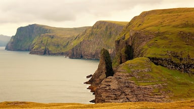 I took this photo at Sørvágsvatn in the Faroe Islands! This isn't a view of the lake itself or the iconic cliffs. But a view of lesser known cliffs right by the lake itself. And the body of water you see is the deep sea :). And the lake was to the right of me. To see both at the same time is a very cool sight, as well. But I like this close-up view the best. Can really get a feel of how otherworldly it is! As the classic views of the lake. I hiked about 4 KM to get to Sørvágsvatn and it was definitely worth it! Some other tourists as well, but not nearly as many as the peak of summer. I'm glad I went on that late August day! One of my favorite memories of 2018. 