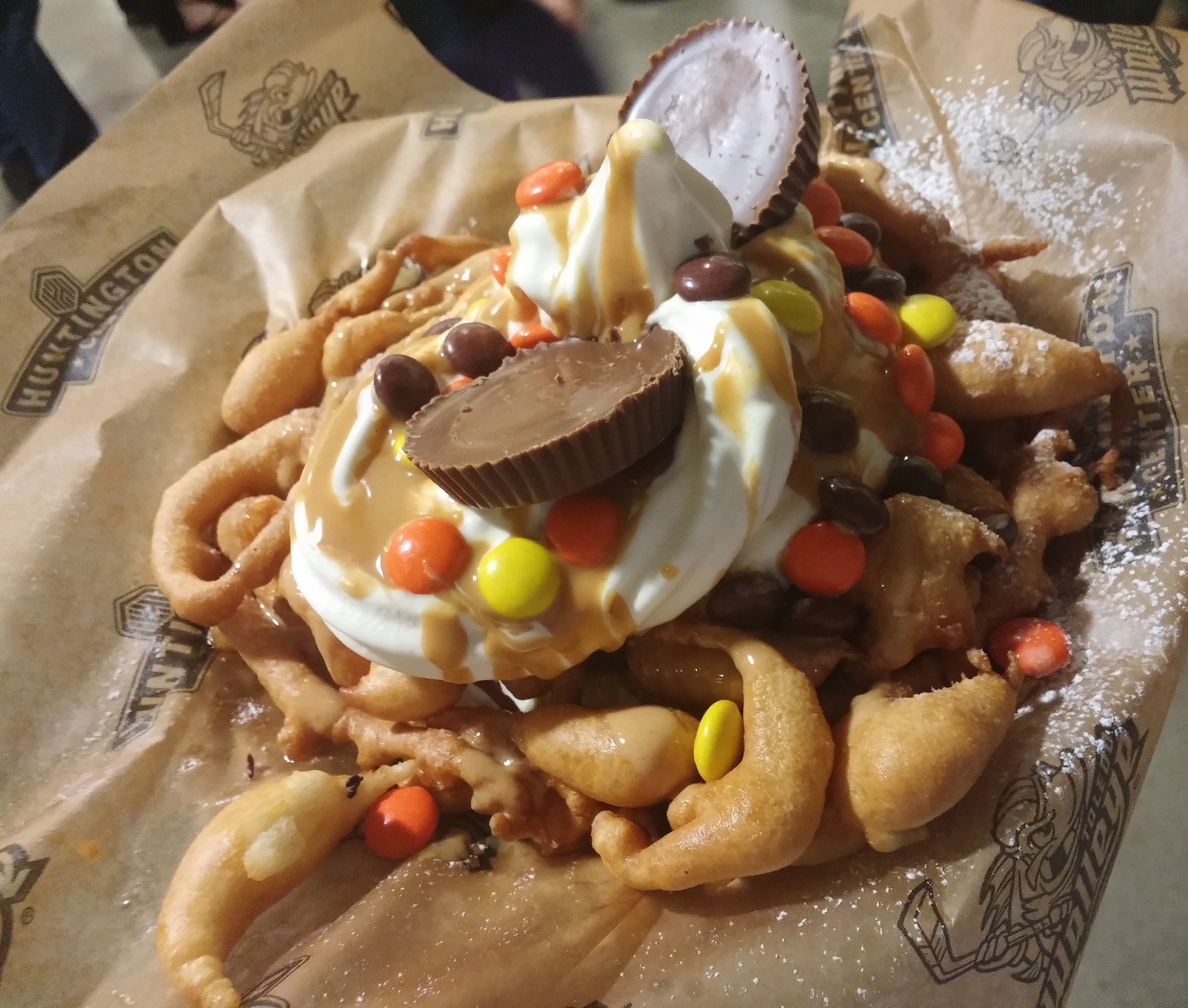 It's a Fundae served up at the @ToledoWalleye hockey game!!!

A vanilla soft serve sundae topped with peanut butter sauce, Reece's Pieces and two Reece's Peanut Butter Cups served on top of a funnel cake!