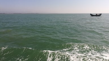 Lone boat floats on sea.