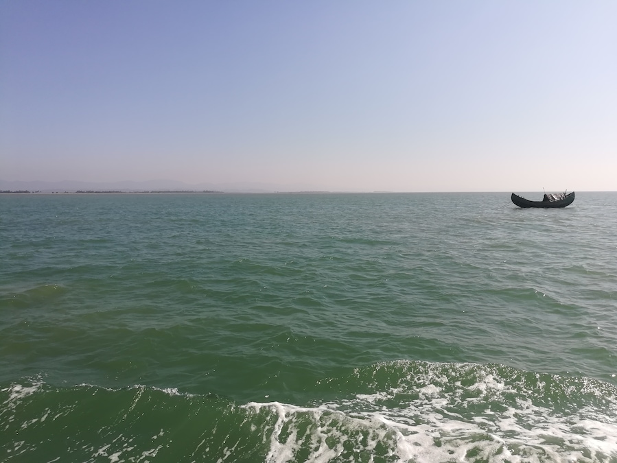 Lone boat floats on sea.