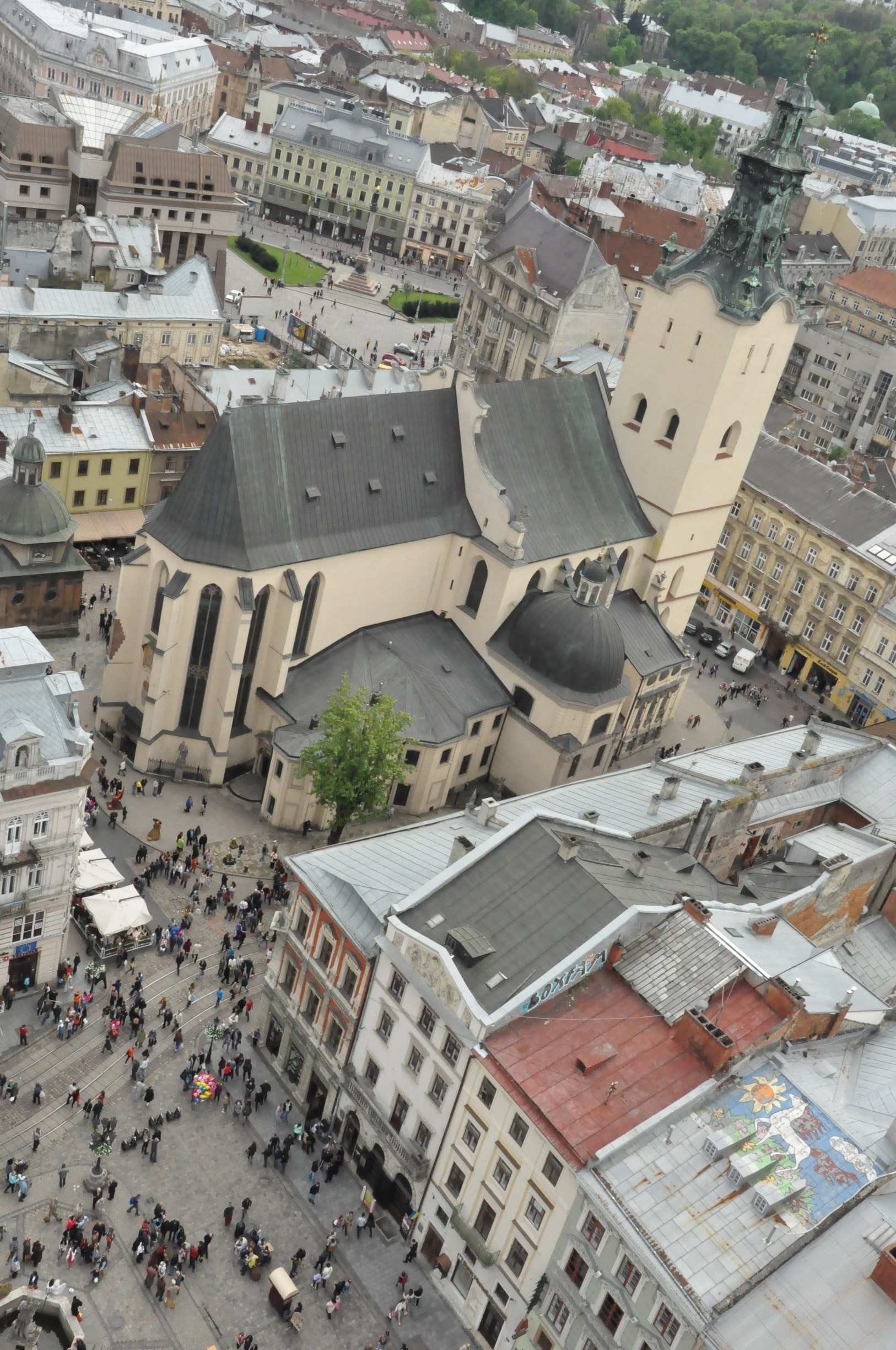 Lovely view of old Lviv from the top of the tower in the center of Ploscha Rynok.  That's the Latin Cathedral, one of the oldest still-active churches in the city.  To climb the tower, go up the first four flights of stairs to the ticket desk.  The way is clearly marked with signs in multiple languages, including English.  At the desk, pay 10 hrivna and then keep climbing up, up, and up until you reach the open deck at the top of the tower.  Then enjoy the view!