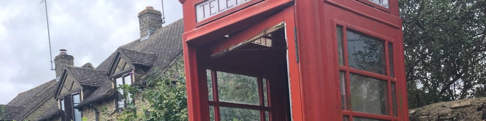 Abandoned telephone booth along the pathways in the middle of the Cotswolds
