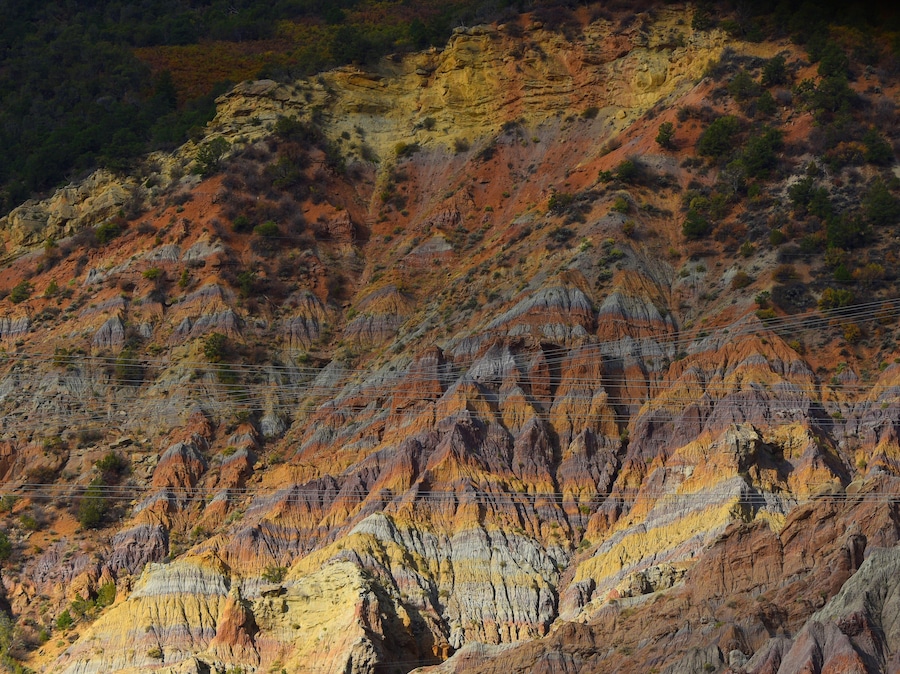 While driving in the early morning from Riffle to Meeker, this mix of old wearing mountains and modern power-lines just struck me.
The sun just lit the face with the raged edges right, and the power-lines just in front is a remainder that it is the new power.
I think it is #Golden with al the vibrant yellow of the rock layers.