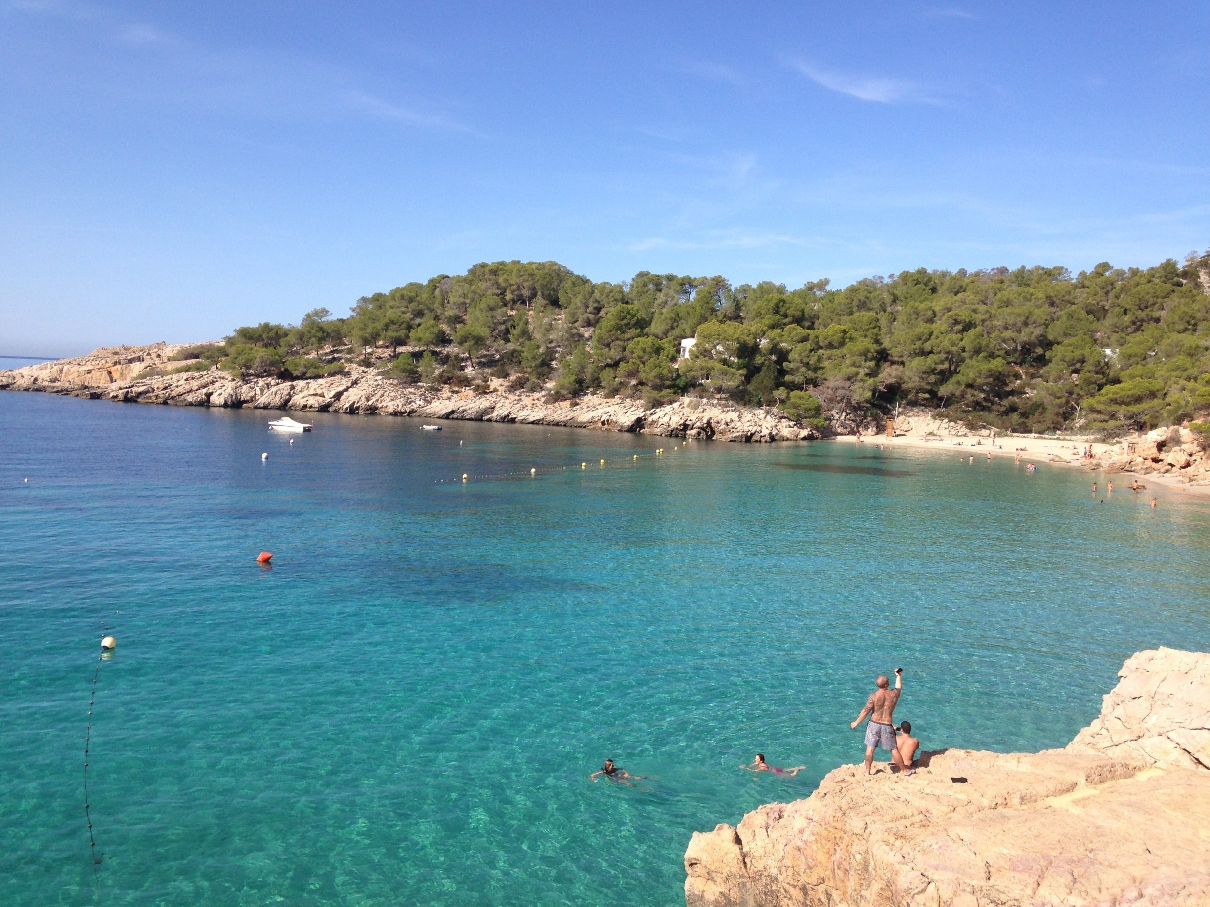 Cala Salada is definitely a beach you don't want to miss if you visit Ibiza! Just a short taxi ride from San Antonio, there are 2 separate beach areas to enjoy.  The rock pictured below is a great place to jump off into the clear sea water below!

#beach