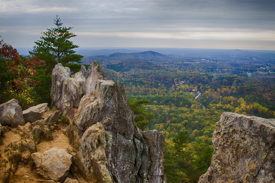 Crowders Mountain State Park has a wealth of great trails which end with great views of North Carolina piedmont. The two main destinations are Crowders Mountain (2.8 mile walk from Sparrow Springs Access) or the Pinnacle or King's Pinnacle. The Pinnacle trail is a pleasant 2 miles trek uphill through rich forest. The last little bit has some rock scrambling with signs that urge carefulness. But the views are stupendous, especially with fall colors in full display. (About 45 minutes west of Charlotte, NC)