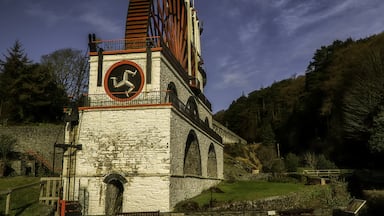 The Laxey Wheel which is also known as Lady Isabella is built into the hillside above the village of Laxey in the Isle of Man. It was built in 1854 to pump water from the Glen Mooar part of the Great Laxey Mines industrial complex It is the largest working waterwheel in the world.
