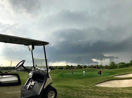 value: "Springtime storms in Texas.  These golfers were not too worried about the wall cloud coming their way.  The storm was tornado warned shortly after this photo was taken. "
