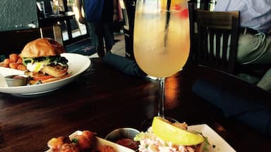 Holy Flavor explosion! Lobster Roll sandwich...Maine lobster tossed in creamy herb citrus sauce with chopped romaine lettuce served in a warm toasted brioche roll and a side of sweet potato tater tots. Paired with a refreshing peach Sangria. This place is a must when you are in Ocoee.