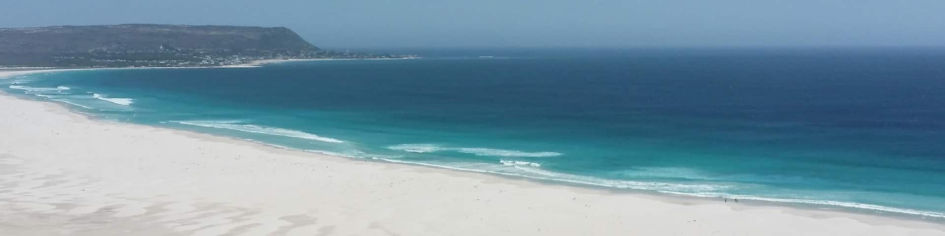 Extremely beautiful beach almost empty of people except for a few surfers. White and soft sand, a bliss!