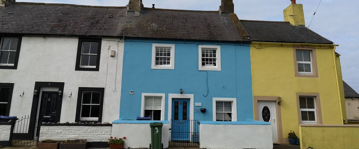 Colourful cottages by the sea in Allonby.