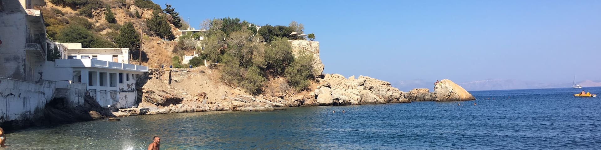Therma ! 2 kms away from the port with a very clear sea. Its not very modern but good to go. You can take a boat 200 meters from the port to come to Therma for 1 euro