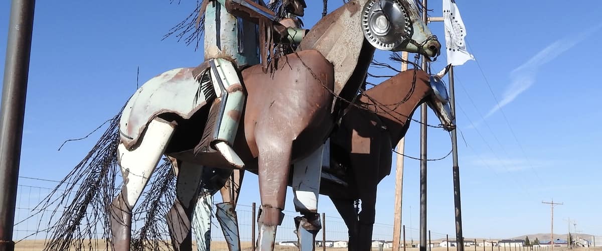 Nin-na-stako: Chief Mountain is constructed of recycled materials and remnants from the flood of June 8, 1964. Old rusted barbed wire was used for the tail and mane of the horses. The base is made from sandstone harvested from the Two Medicine Catholic Mission which was built in the late 1800's. This is located near the Montana and Canada Border on Hwy. 89. The Canadian border is 1.25 km north from this sculpture.
#OnTheRoad