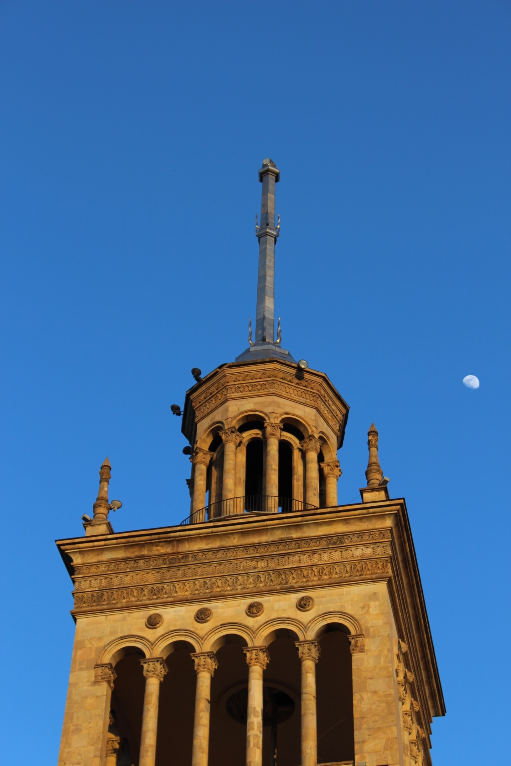 View of the moon rising next to the spire atop the Georgian National Academy of Sciences building in Tbilisi, Georgia. 