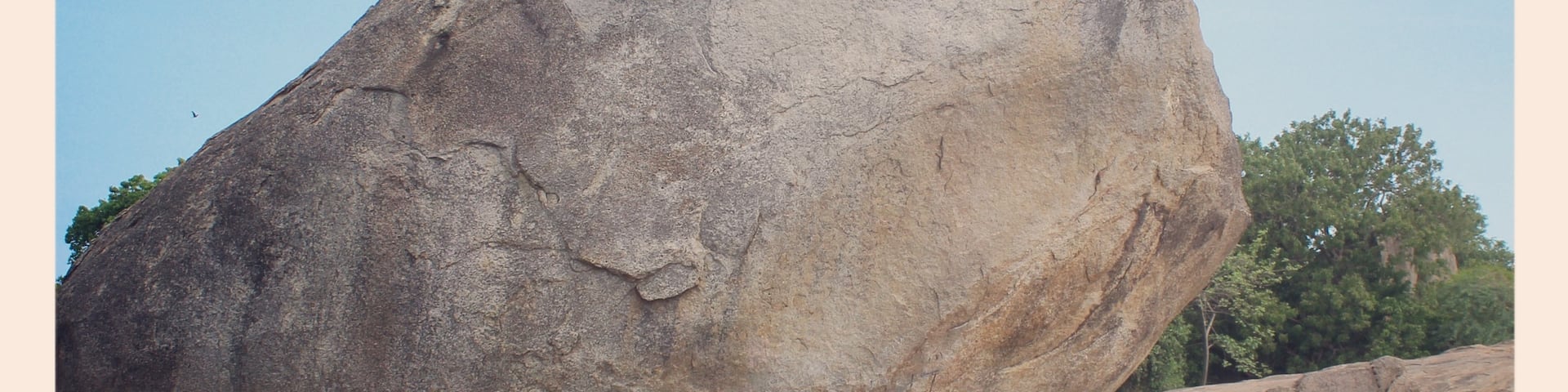 This is a photo of me trying to push 'The Krishna's butterball.' The stone is called Krishna's butterball because even when its shape is a circular one still it manages to balance on a inclined plane and even after enormous efforts the stone was not be able to rolled down the surface.