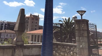 This very high statue of a woman looking through a telescope in central Santander is called Into the future 