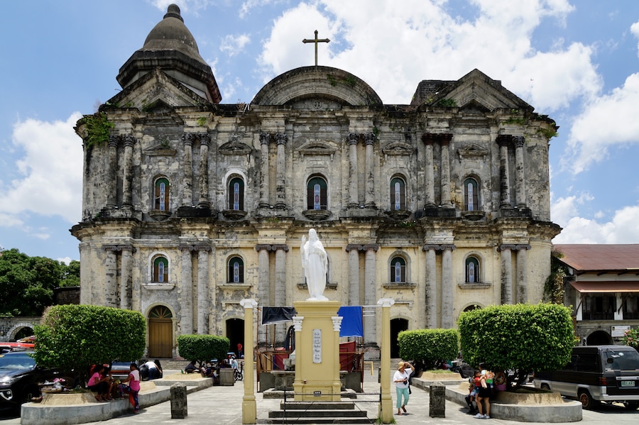 The facade of the Taal Basilica, the Minor Basilica of St Martin of Tours (the Patron Saint of Taal), Taal City, Batangas, Philippines (Apr 2018): though originally founded in the 1570s by the Augustinians, the church has been re-built or restored several times following eruptions of the Taal Volcano and earthquakes.