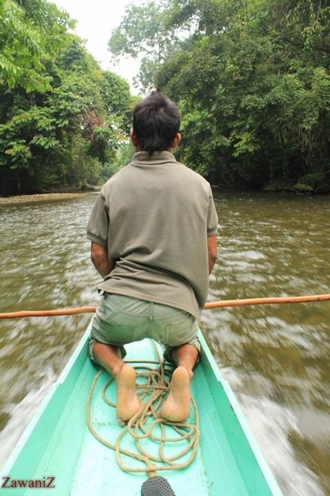 Ride on a long boat through a clear water stream.