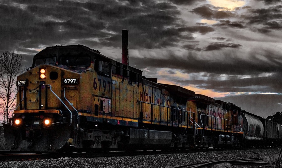 Local train making a night run through town.