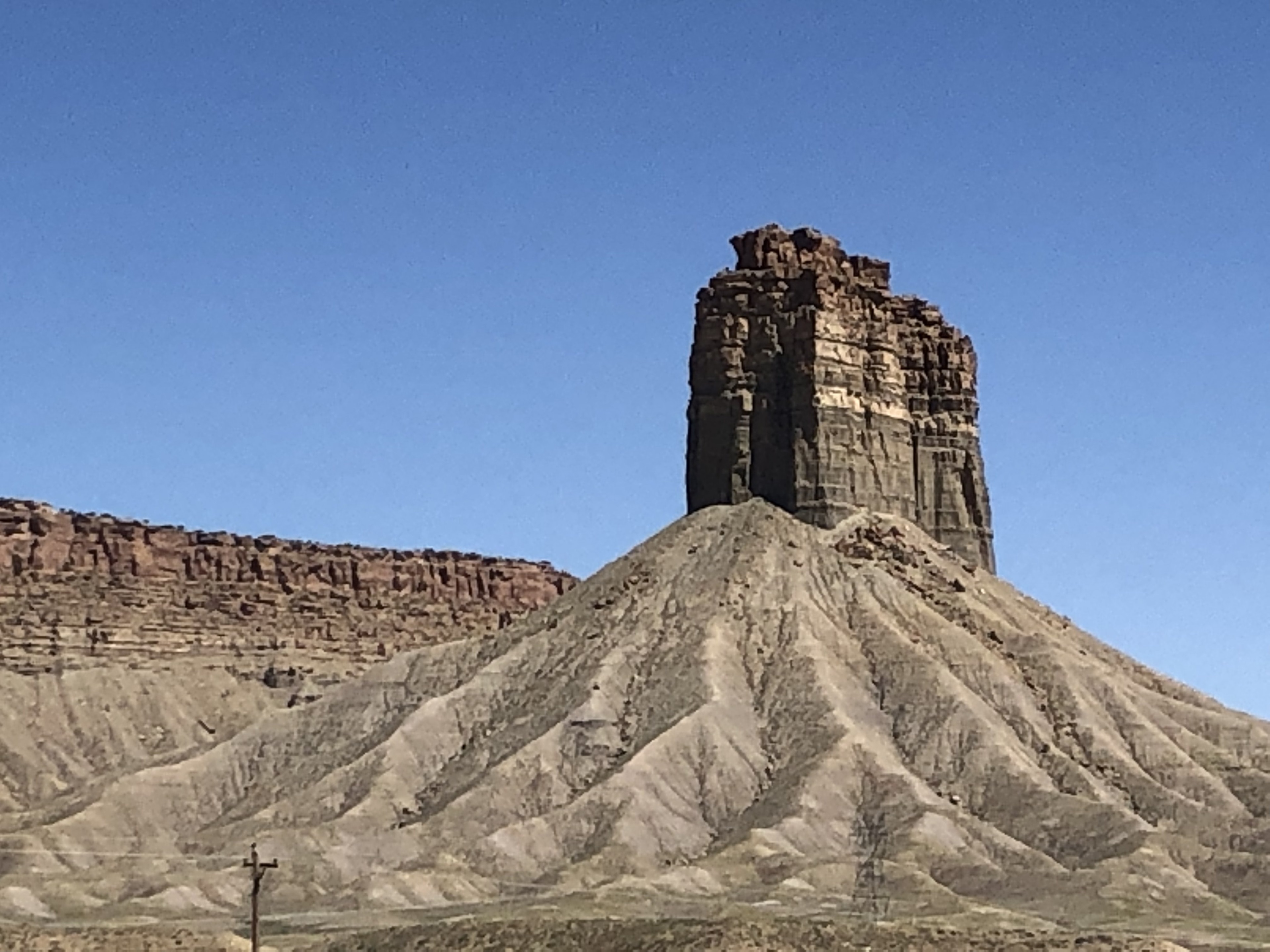 On our way to the Four Corners(CO, NM, AZ, UT) 
we stopped to take a photo of this butte that was about 250 feet tall. I could see it driving at least 25 miles ahead.