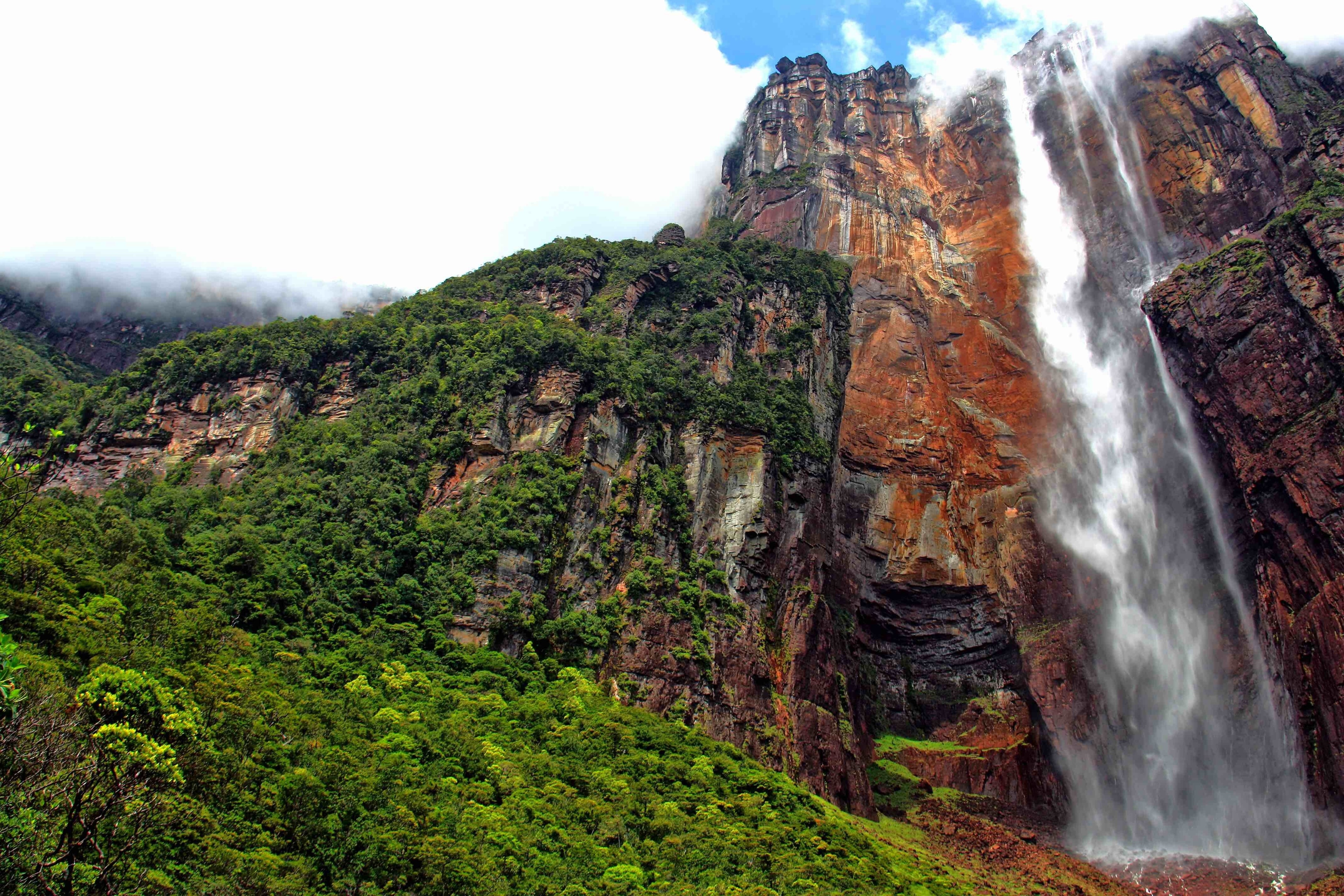 World's tallest waterfall at 979 meters. Angel Falls, Venezuela was on my bucket list and luck had it that I would be in the country for business a few years ago. On a weekend off, I made my way to Canaima park (only way to get there is by air) and then took a 3 hour boat ride up the Churun River in a motorized dugout boat to the trail up to the falls. The views along the way were pretty cool and like a completely different world. Well worth the trip on its own. At our destination we were dropped off and hiked up through the jungle on a well used trail for a few kilometers before arriving at the pools near the base of the falls. Looking up you can appreciate the drop. The water turned to mist on way down and then pooled over several other small falls on their way down to the river. The pools were the perfect place to have a swim and relax while taking in the views of the tepui and surrounding landscape. The locals said it was good luck to drink the water from the falls. It was nice and cool and tasted as pure as any bottled water. I guess the luck was with me as it did not rain until we were almost back at the camp in Canaima. Then the skies opened up and it poured for hours. I would love to visit again and hopefully the political situation in Venezuela becomes more stable so that others may be able to enjoy this amazing place.