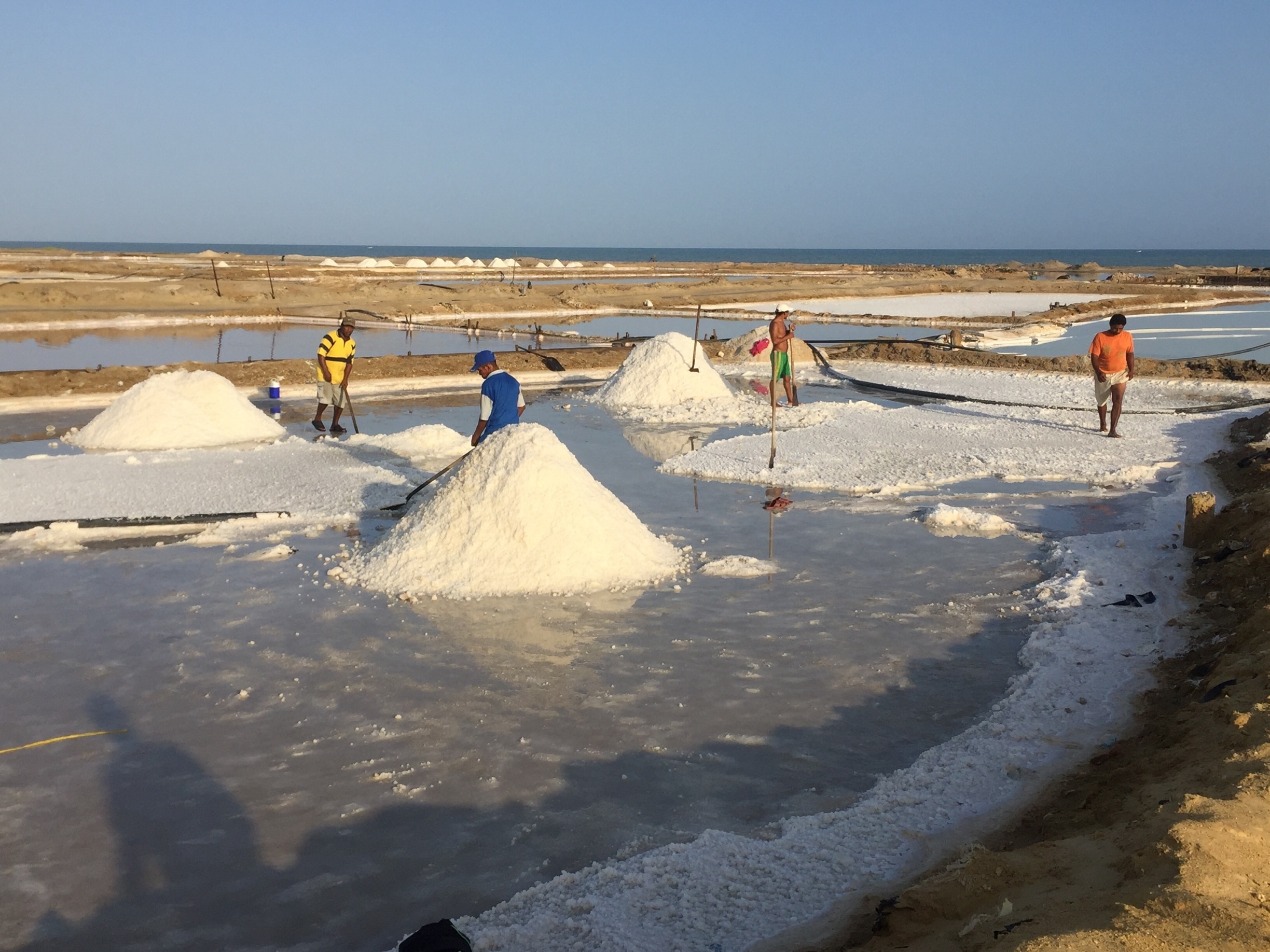 People collect the mineral in the salt ponds of Manaure, up early to avoid the heat. The landscape in this area, measuring 4,200 hectares, is covered by salt hills reflected in water wells.