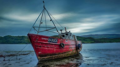 A wrecked fishing boat "Sabrina" in its final resting place on the banks of Mulroy Bay in County Donegal, Ireland.