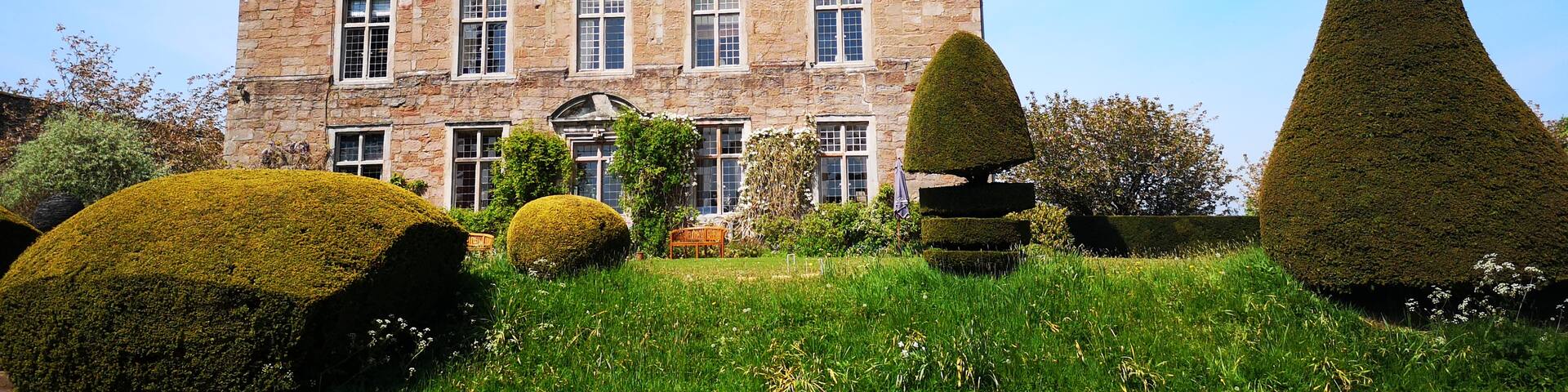 The gardens here are small but nice to look round and there's a lovely kitchen garden tea room. Pets allowed in the courtyard cafe but not in the gardens. £4 entry fee. Look for the Romany caravan and admire the giant topiary.