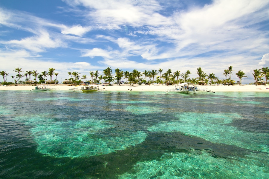 Cerulean skies over turquoise green waters greet us as we approach the pristine beaches of Kalanggaman Island in Palompon, Leyte, Philippines.