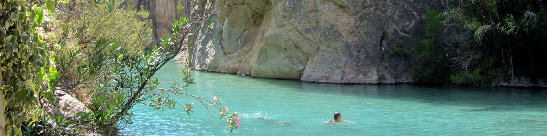 Clear blue waters and a stunning canyon surround this little river near the town of Montanejos, Spain. It is a short drive from the big town of Valencia, and was my favorite place to escape the city and the heat when I lived in Valencia. Hardly any crowds, you can swim down the calm springs to find underwater caves, mini waterfalls, and of course nearby restaurants in the town for sangria and tapas. #LiveLikeALocal