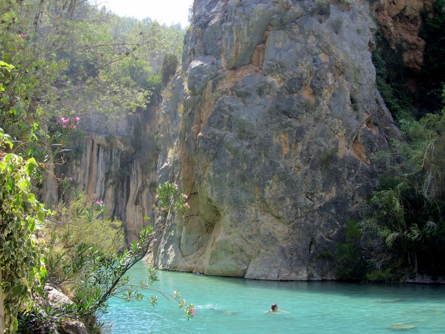 Clear blue waters and a stunning canyon surround this little river near the town of Montanejos, Spain. It is a short drive from the big town of Valencia, and was my favorite place to escape the city and the heat when I lived in Valencia. Hardly any crowds, you can swim down the calm springs to find underwater caves, mini waterfalls, and of course nearby restaurants in the town for sangria and tapas. #LiveLikeALocal