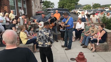 A road trip along the Crooked Road takes you on a musical journey through southwest Virginia offering street jam sessions like this one in the town of Floyd on Friday nights. #OnTheRoad