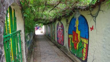 Walk way from boat dock into village. There are several murals along this walkway. Beautiful paintings!  Have a drink at the bar on the right side of dock and watch the boats arrive/leave.