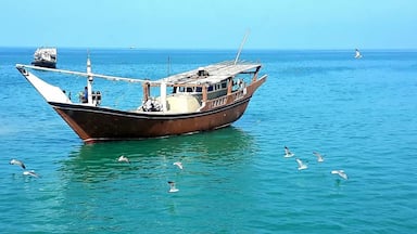 A Traditional Dhow floating on the Blue waters of the Sea on way to Masirah ...takes almost an hour from mainland Oman coast to coast.....a wonderful journey
