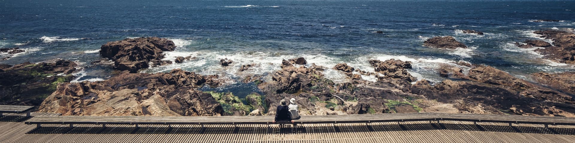 Elderly couple sitting in  front of the atlantic ocean and blue sky.
#porto #BVSBlue #portugal #atlanticocean