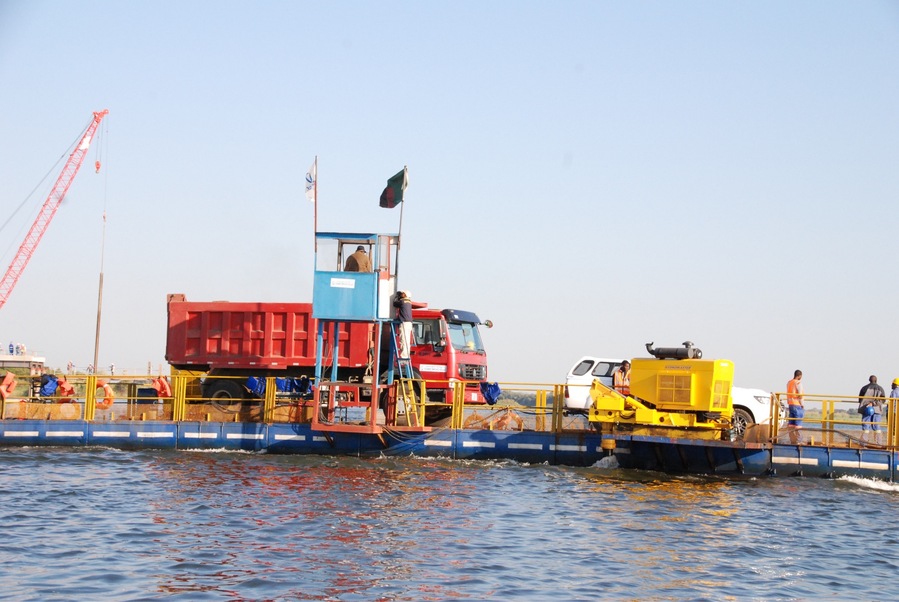This barge is on the border crossing from Zambia and Botswana. Does look like much, does it? This is the only way for trucks to get across the Chobe River from Zambia into Botswana, also near the Nambia Border. One truck at a time, each way. I lost count after 250 trucks. At the passport control spot, we asked how long the drivers must wait to cross, and was told that it is between 10 and 14 days. DAYS. There were trucks carrying everything from Caterpillar tractors to bundles of pipe to furniture. Trucks were dust covered, and the drivers built little lives waiting for their turns - showering in their cabs, cooking meals on the side of the road. An industry had sprung up on both sides of the river, with little bars, food stalls, shops, showers. Prostitutes wandered from truck to truck in high heels and short shorts. There is a bridge going across this River, about half a mile wide at this point. It's something that the Army Corps of Engineers would have put up in a day or two. We were told, rather proudly, that it would be in fished in about five years. The business part of my brain realized what a huge economic waste this is. As usual, vendors hawked their wares, and uniformed officials took their time to stamp your passport, sanitize your shoes, and wave you on.
