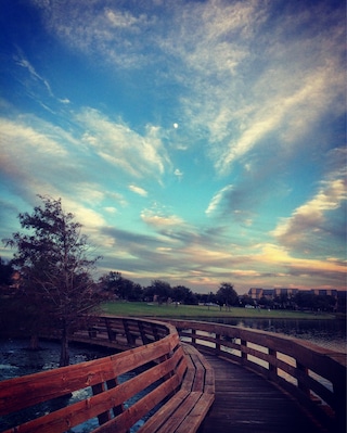 Quaint little park with some walking trails and pond. Located next to a small shopping center. Nice place to spend an afternoon.
This picture was taken on the wraparound bridge on the water.