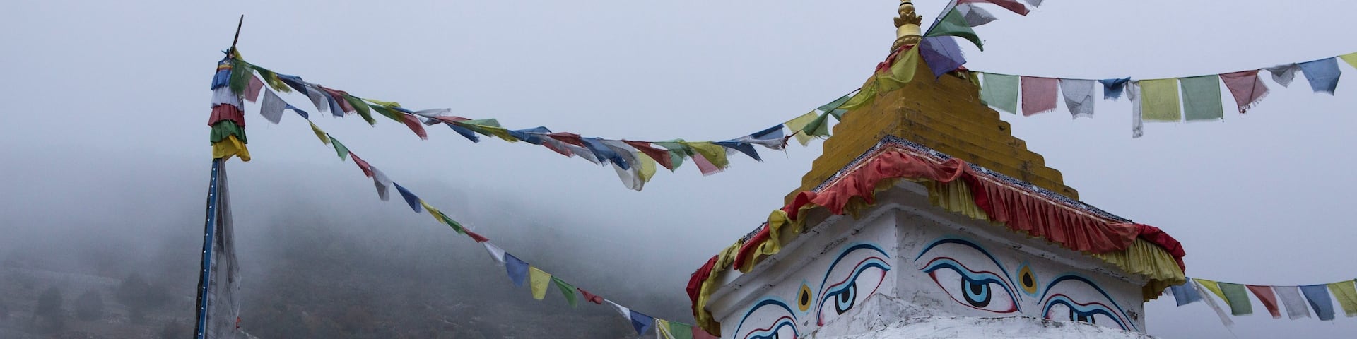 A chhorten in Namche Bazaar with angular view of Namche.