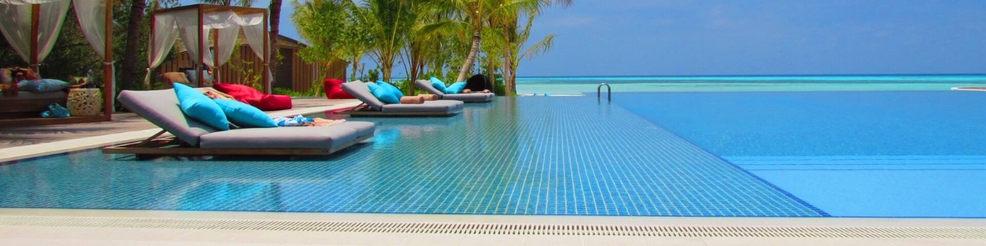 Hard to tell where the pool ends and the Indian Ocean begins.  The blues and colours are stunning.  Taken at the main pool at Club Med Finholu Villas in The Maldives.