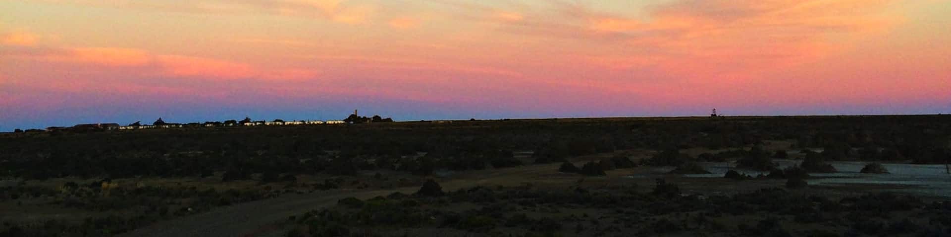 Get away from the world at Bahia Bustamante on the Argentinian coast, an old seaweed town come sheep estancia come small hotel. With a private penguin colony, petrified forest, horse rides along the beach and sunsets like this to yourself, this place is unforgettable. 
http://www.nytimes.com/2011/03/06/travel/06bahia-bustamante.html?_r=0